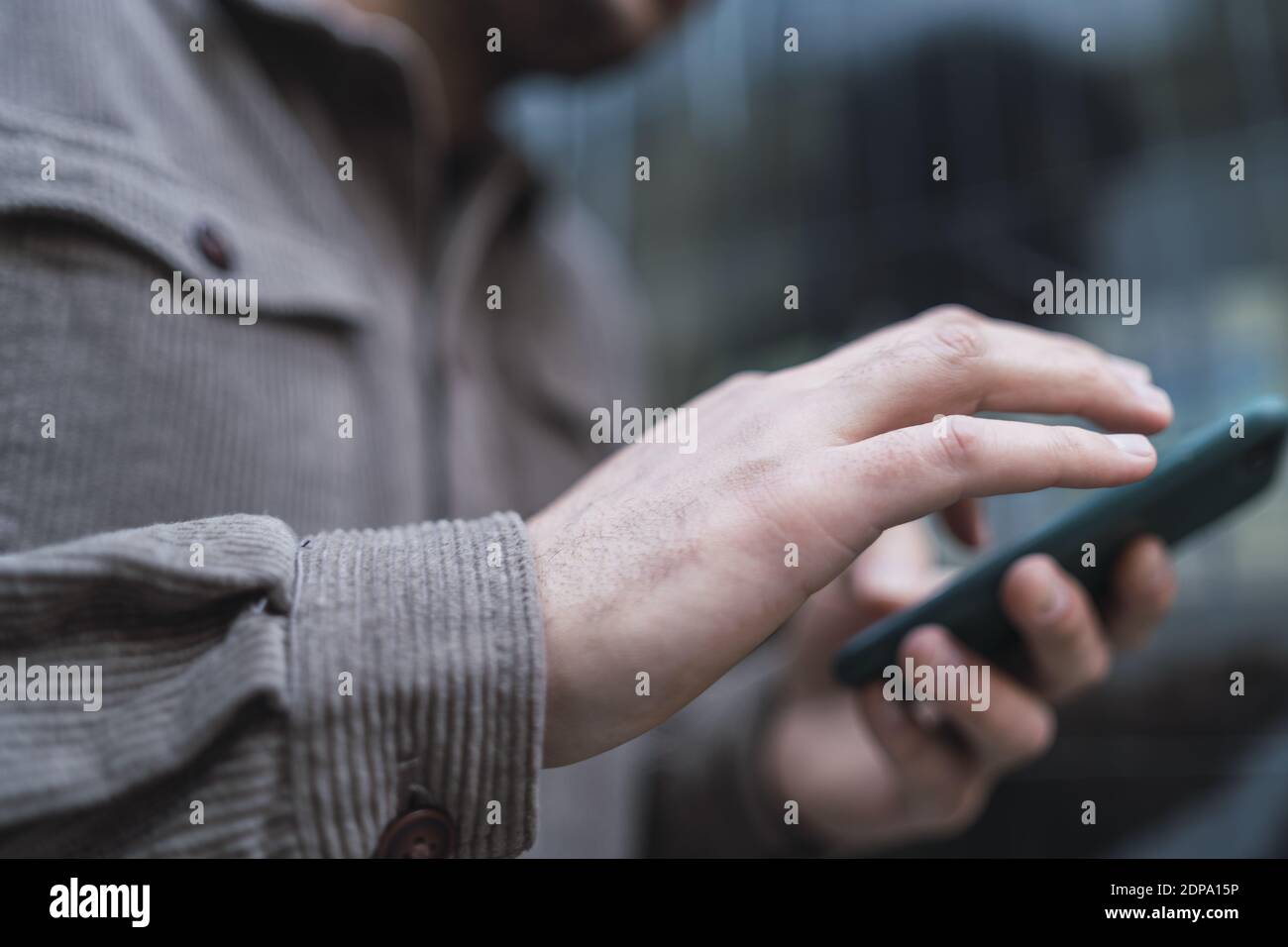 A selective focus shot of a male hand scrolling on the phone Stock ...