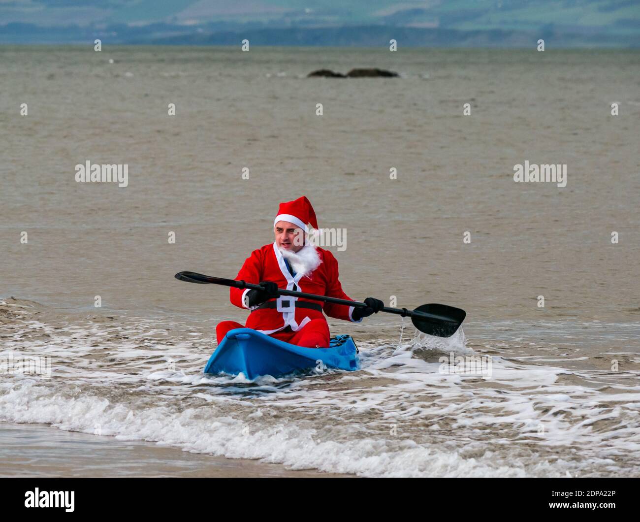 North Berwick, East Lothian, Scotland, United Kingdom, 19th December 2020. Paddle Boarding Santas for charity: a local community initiative by North Berwick News and Views called 'Christmas Cheer' raises over £5,000 funds for families in need Stock Photo