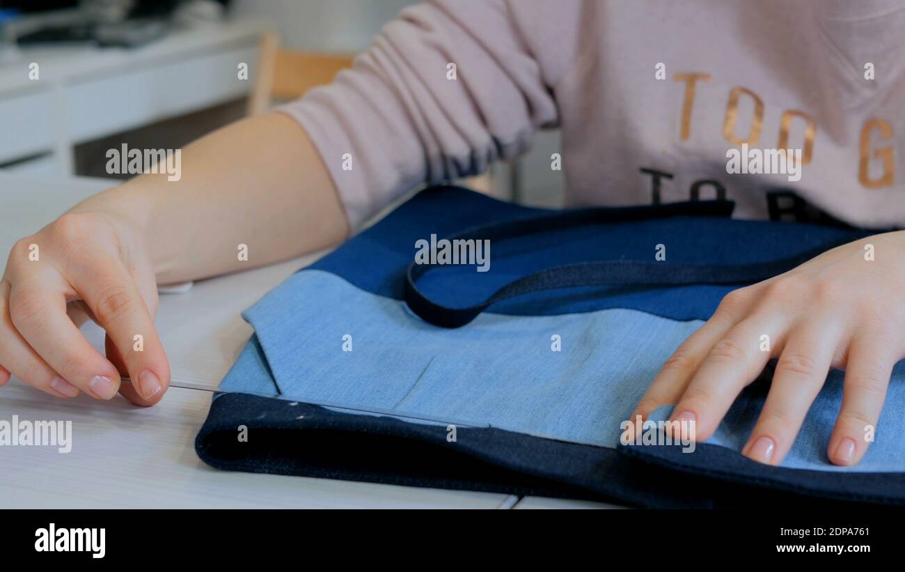 Professional tailor, designer measuring suit jacket for sewing at atelier. Stock Photo