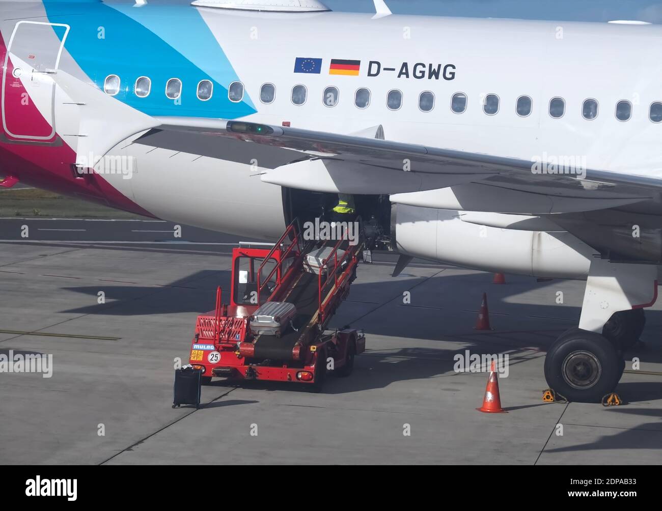 Eurowings airplane at Faro airport in park position is loaded with luggage Stock Photo