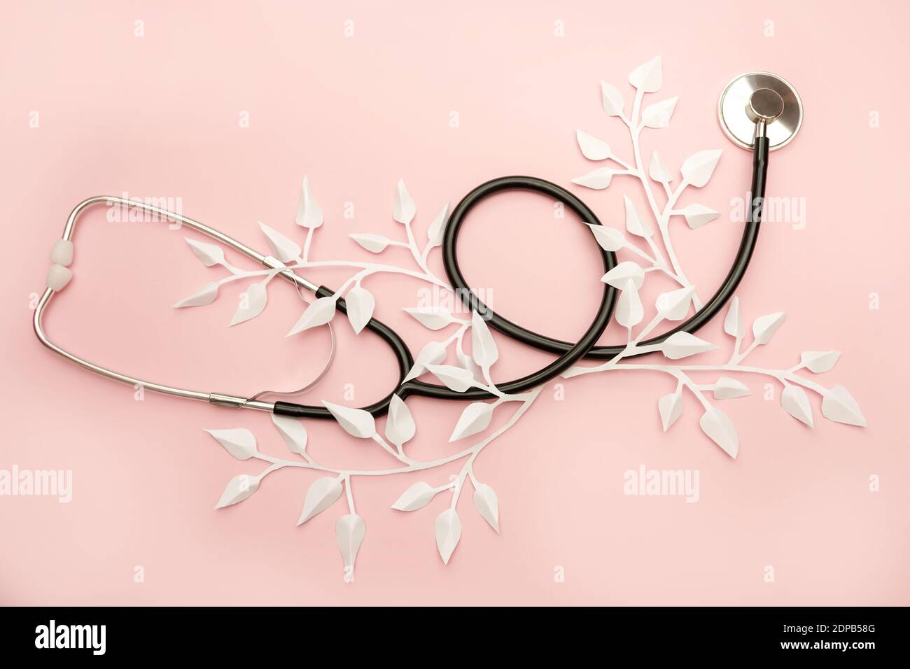 Medicine equipment stethoscope or phonendoscope on trendy pastel pink background. Instrument device for doctor. Stock Photo