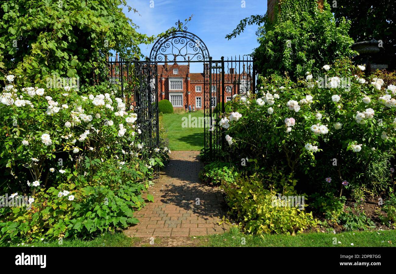 Helminngham Hall Gardens with roses and iron gate. Stock Photo