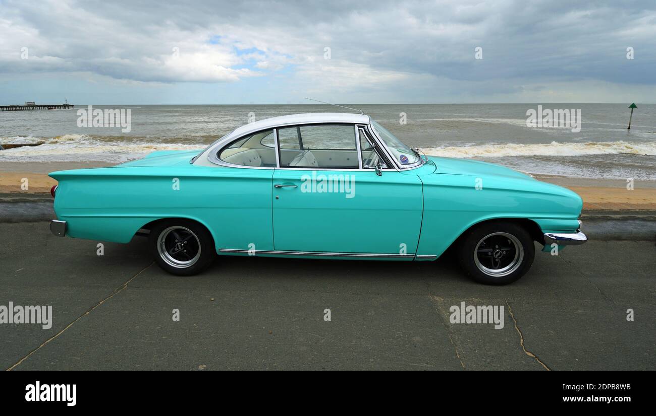 Rare Classic  Light Blue and White Ford  Consul Capri Motor Car parked on seafront promenade with beach and sea in background. Stock Photo