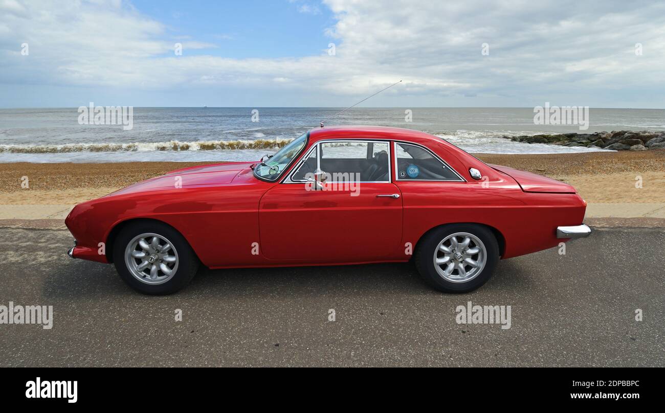 Classic red Reliant Scimitar parked on seafront promenade. Stock Photo