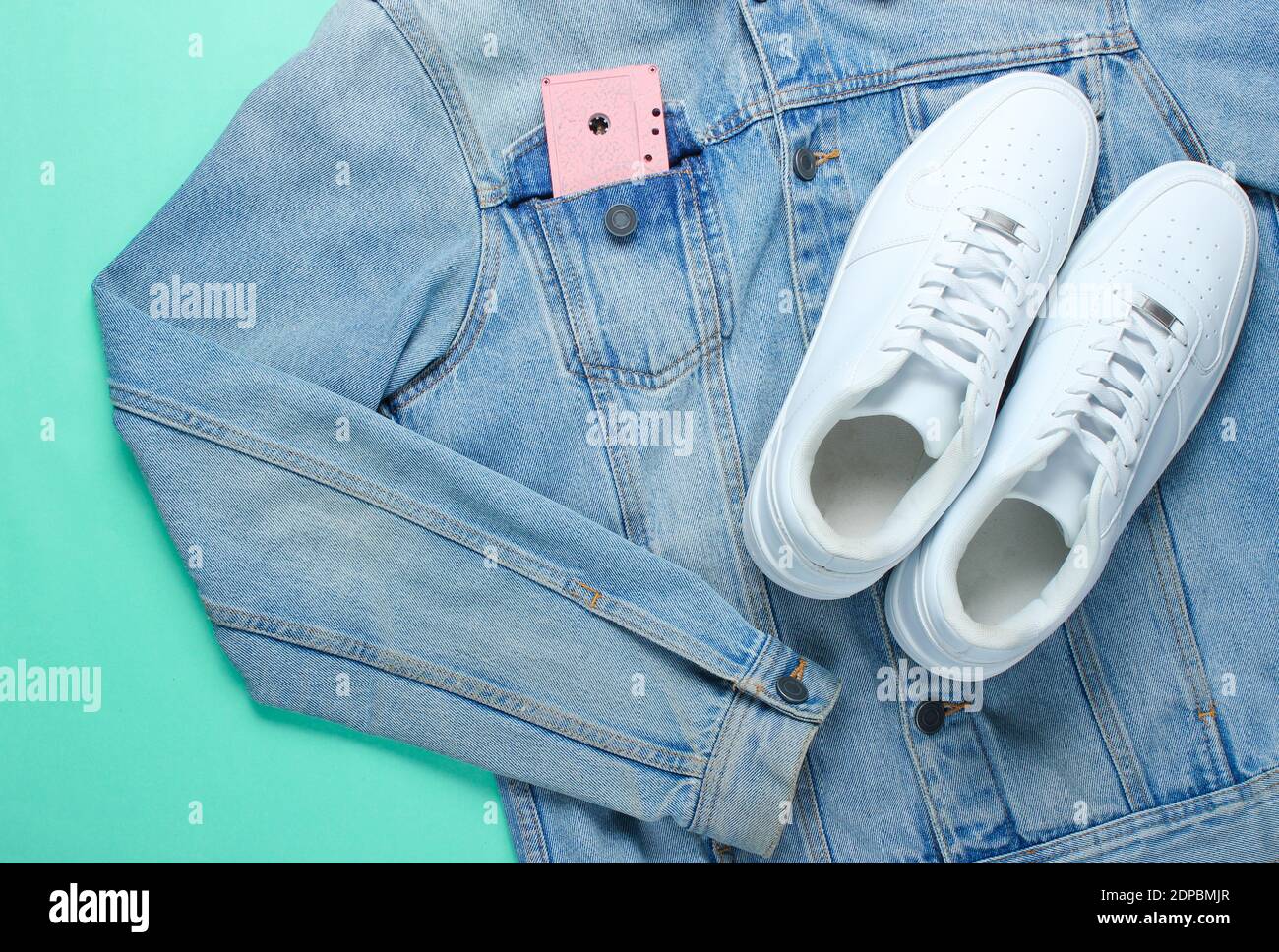 Flat lay style white hipster sneakers with a denim jacket, audio ...