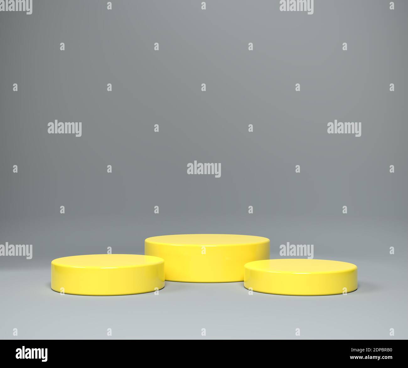 Three differently sized pedestals in the color of the year 2021 illuminated yellow on a seamless background in ultimate gray. Stock Photo