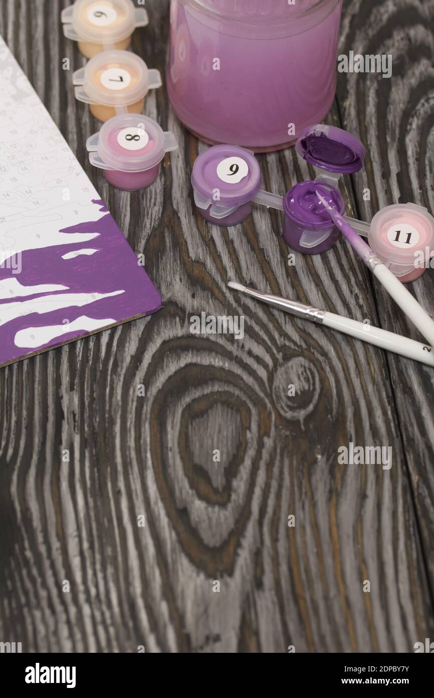 Brushes and paints for painting. Nearby is a fragment of a painted