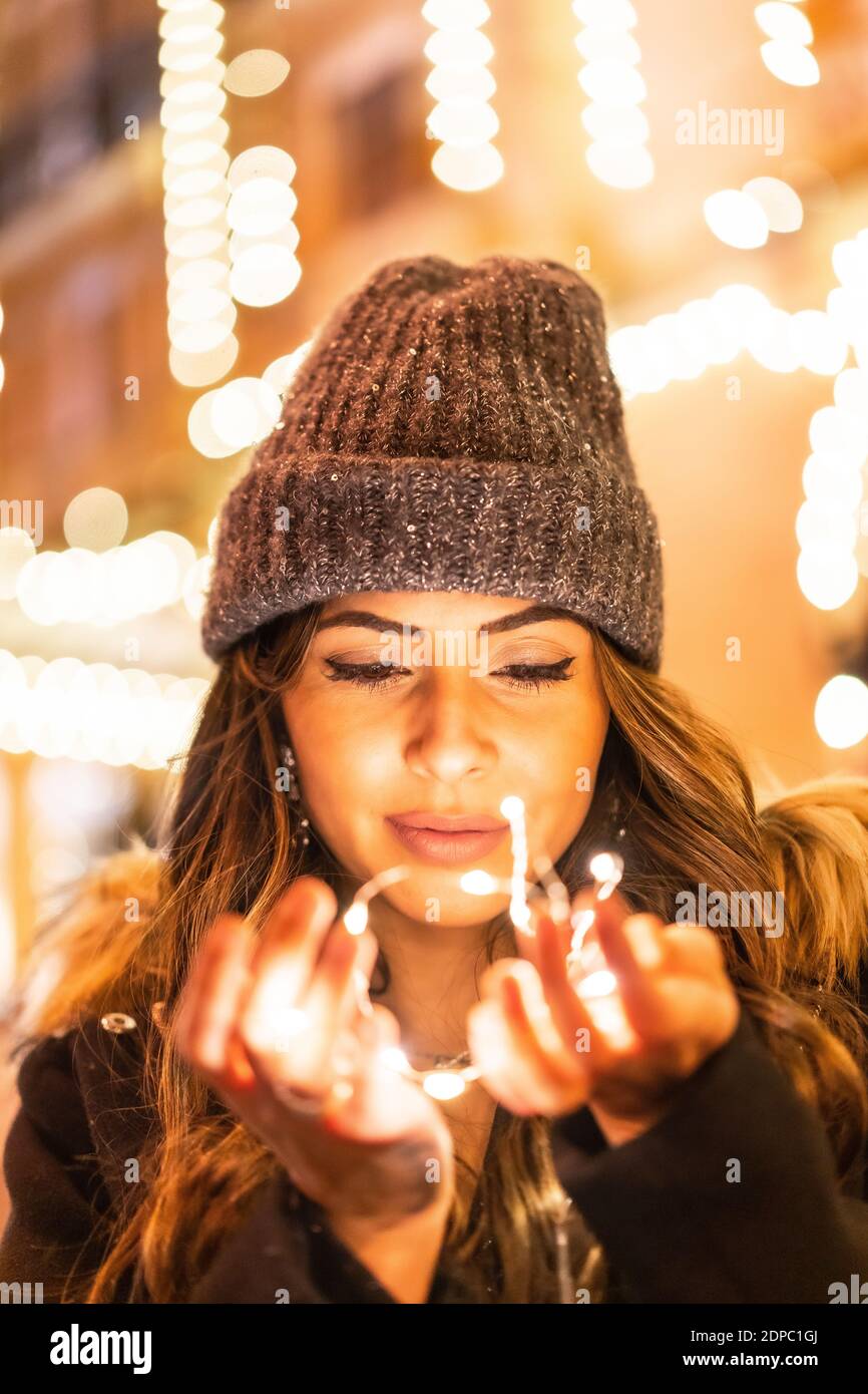 holding Christmas lights outdoors 