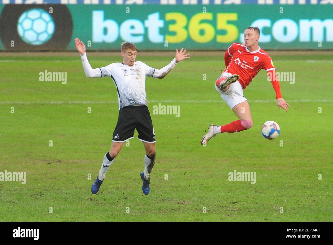 SWANSEA, WALES. DECEMBER 19TH Jay Fulton of Swansea City and Cauley Woodrow of Barnsley battle during the Sky Bet Championship match between Swansea City and Barnsley at the Liberty Stadium, Swansea on Saturday 19th December 2020. (Credit: Jeff Thomas | MI News) Credit: MI News & Sport /Alamy Live News Stock Photo