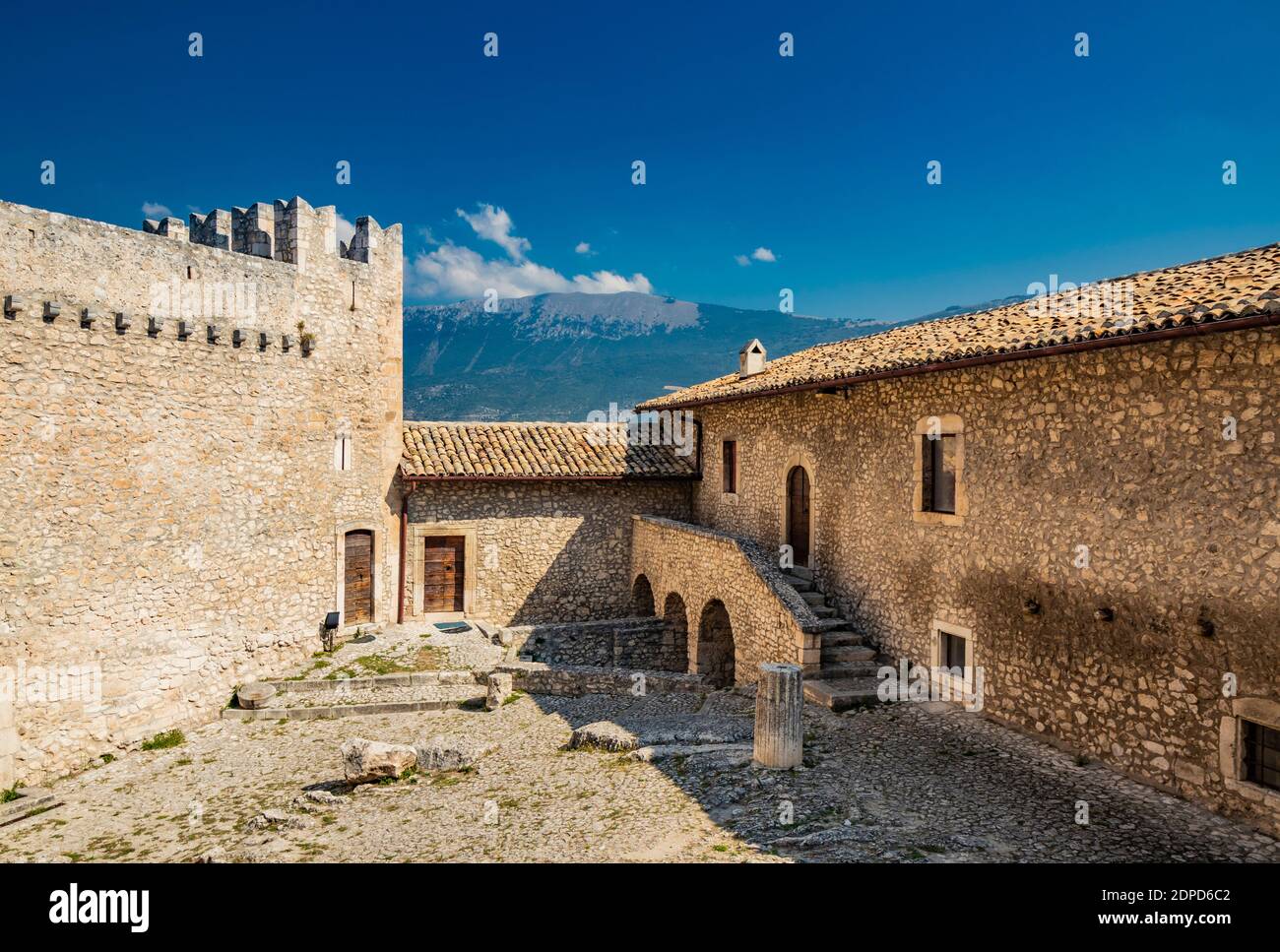 September 13, 2020 - Capestrano, Abruzzo, Italy - The courtyard of the ancient medieval castle, with the high tower, the defensive brick walls, the st Stock Photo