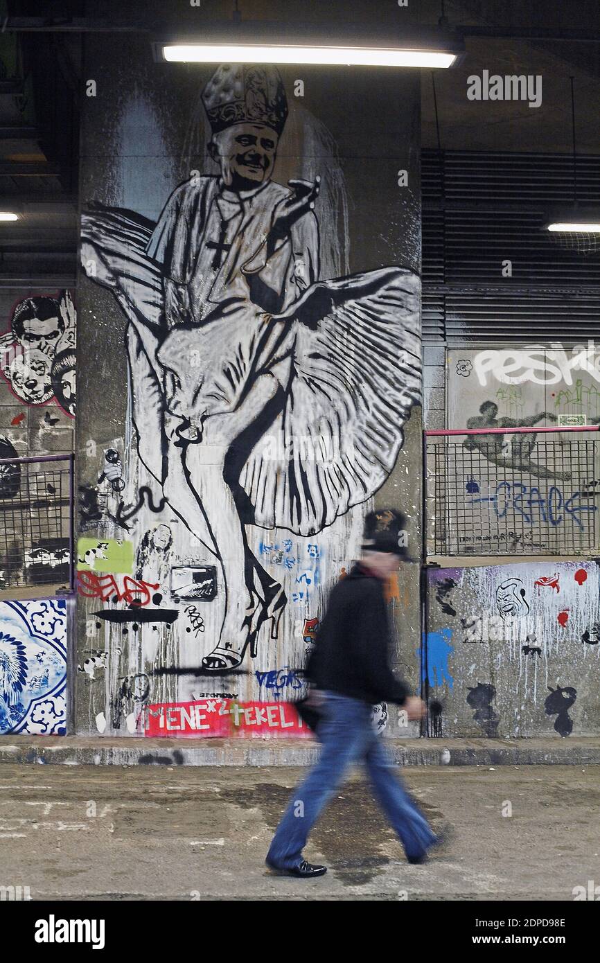 GREAT BRITAIN / London/ Street Art / A man  walks past a graffiti artwork.A subway painted by stencil artists at a giant new exhibition space created Stock Photo