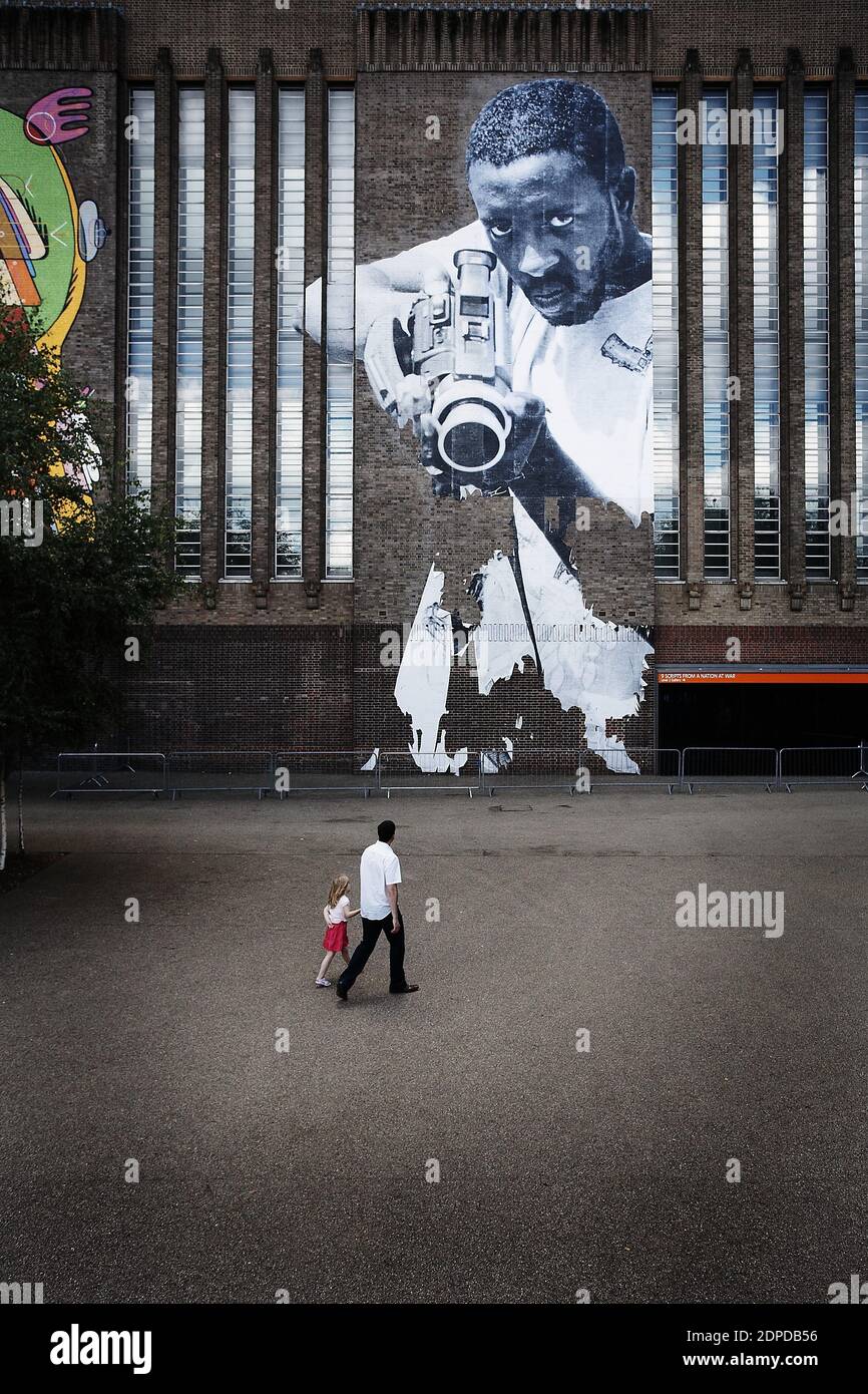 GREAT BRITAIN / London/ Street Art /Tate Modern /JR's paste -up image shows a black man holding what .on firstglance appears to be a gun.On closer ins Stock Photo