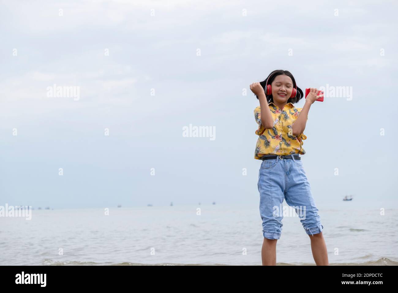 Woman dancing beach jeans hi-res stock photography and images - Alamy