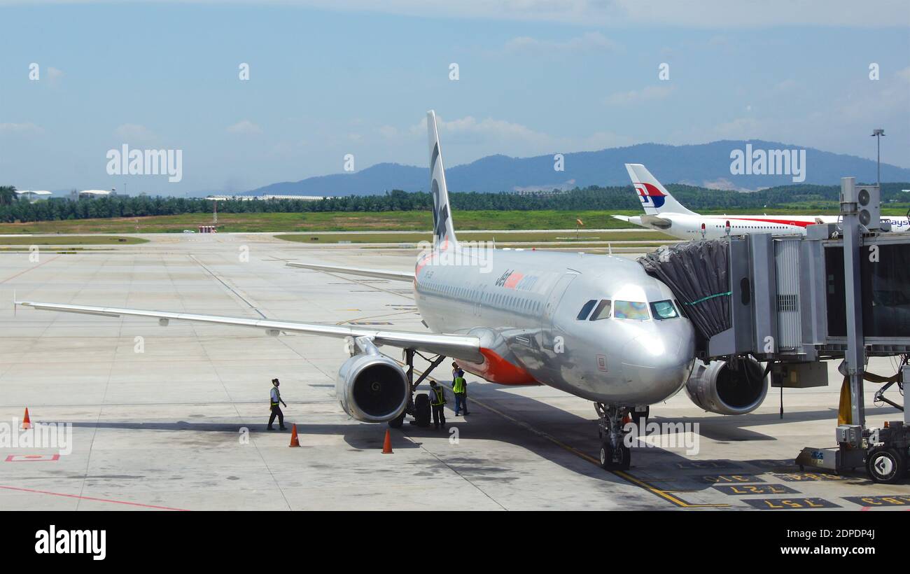SINGAPORE, SINGAPORE - 14 APRIL 2015: A large passenger jet standing on the gate of a tarmac at an airport Stock Photo