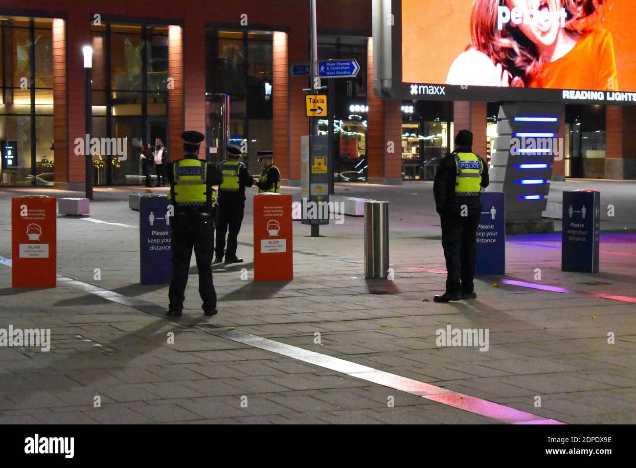 British transport police stand outside Reading train station while on duty during COVID-19 the night before tier 4 was announced. Stock Photo