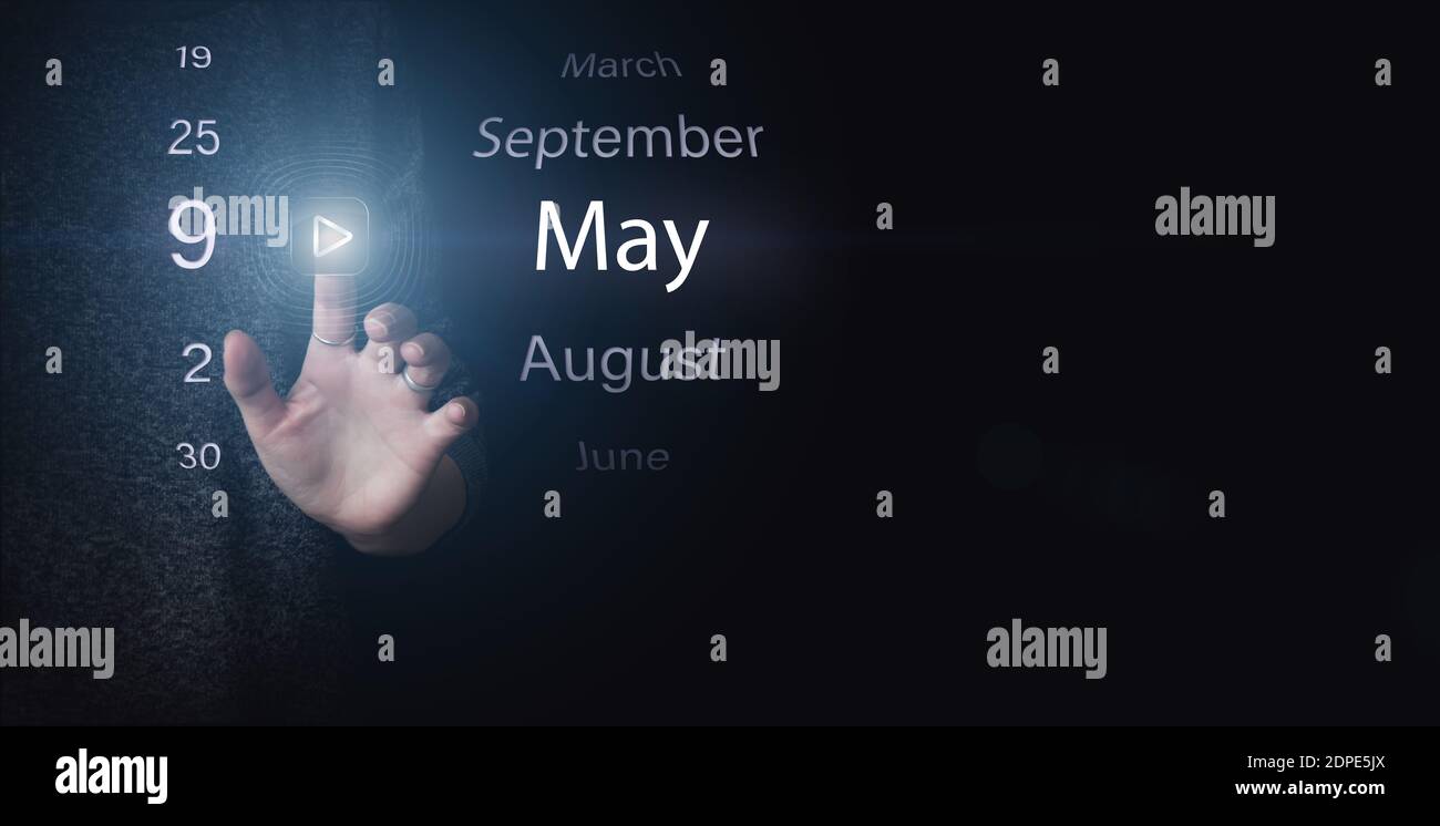 May 9th. Day 9 of month, Calendar date. Hand click luminous icon PLAY and DATE on dark blue background. Spring month, day of the year concept Stock Photo