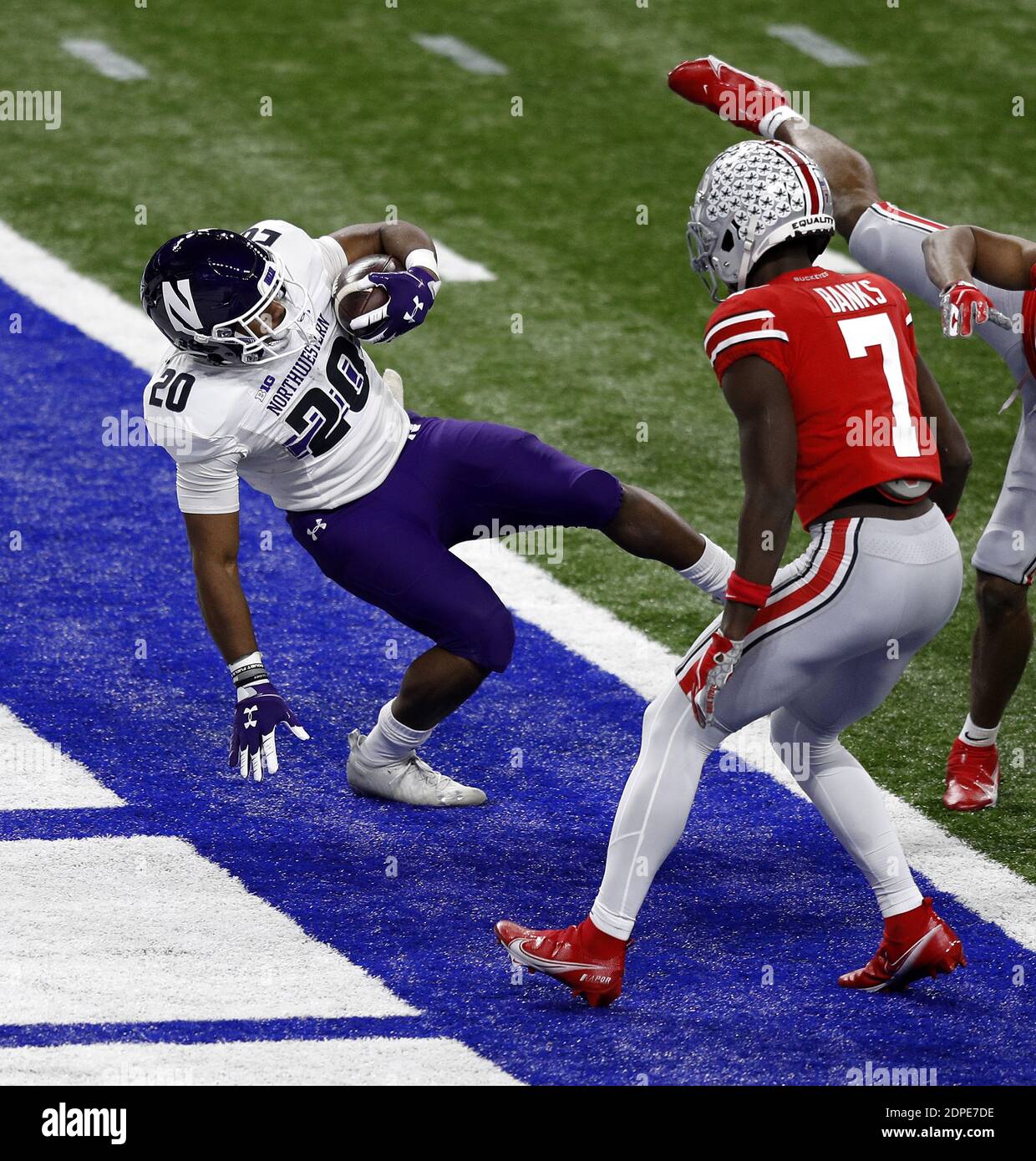 Indianapolis, United States. 19th Dec, 2020. Northwestern Wildcats Cam Porter (20) stumbles into the endzone for a touchdown in front of Ohio State Buckeyes Stevyn Banks (7) during the first half of the Big Ten Championship Saturday, December 19, 2020 in Indianapolis, Indiana. Photo by Aaron Josefczyk/UPI Credit: UPI/Alamy Live News Stock Photo