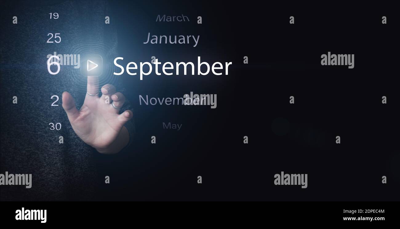 September 6th. Day 6 of month, Calendar date. Hand click luminous icon PLAY and DATE on dark blue background. Autumn month, day of the year concept Stock Photo