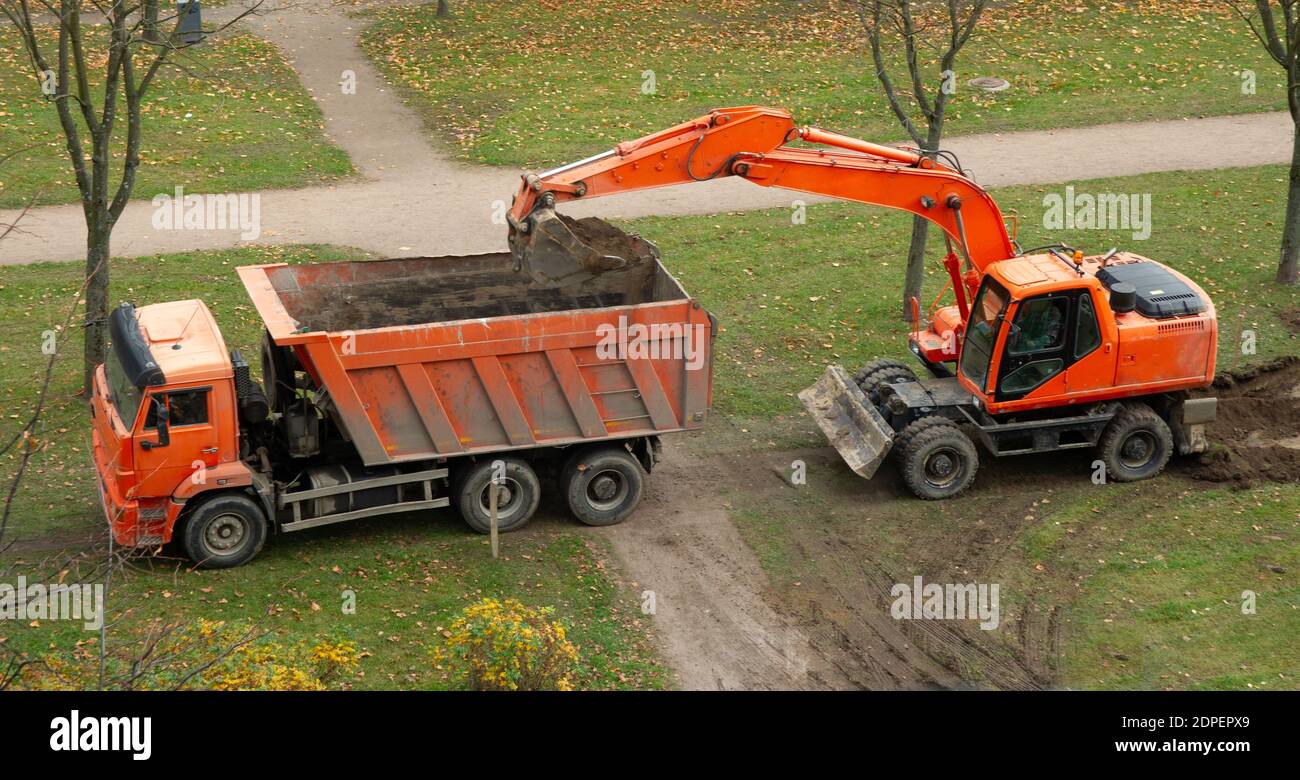 excavator and dump truck. work on the arrangement of tracks Stock Photo