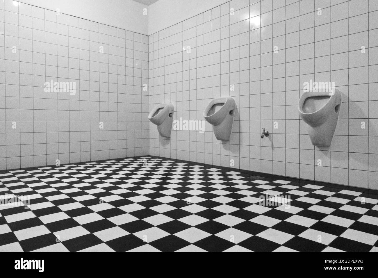Urinals in public toilet restroom Black and White Stock Photos & Images