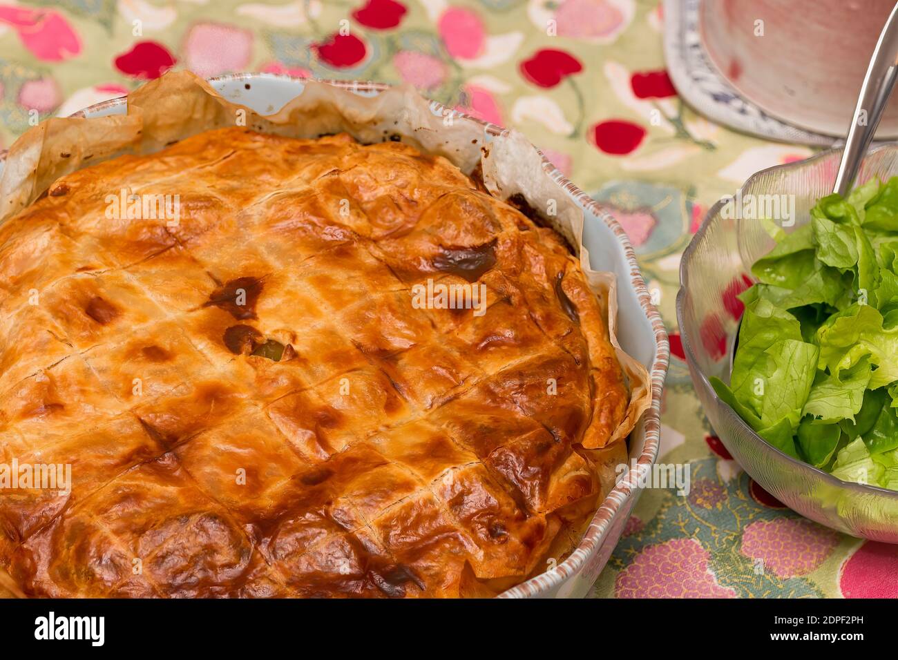 Baked potato pie and salad on a colorful tablecloth Stock Photo