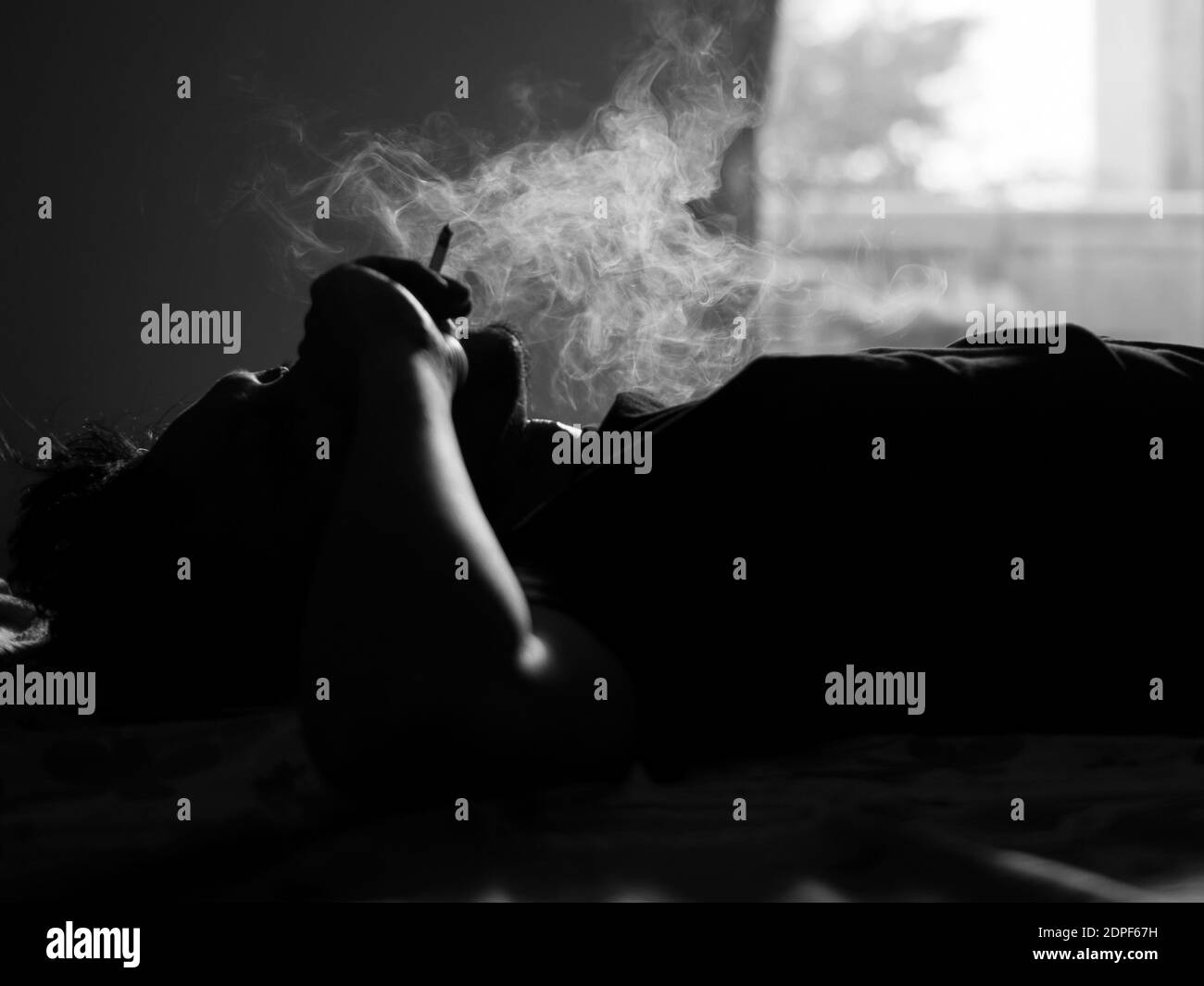 Person lying bed cigarette hires stock photography and images Alamy