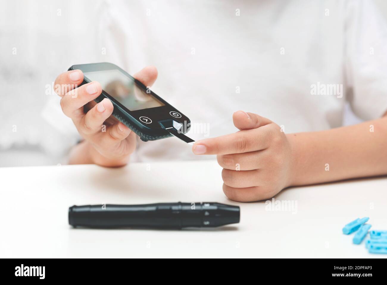 Young boy using checking blood sugar level. Diabetes and