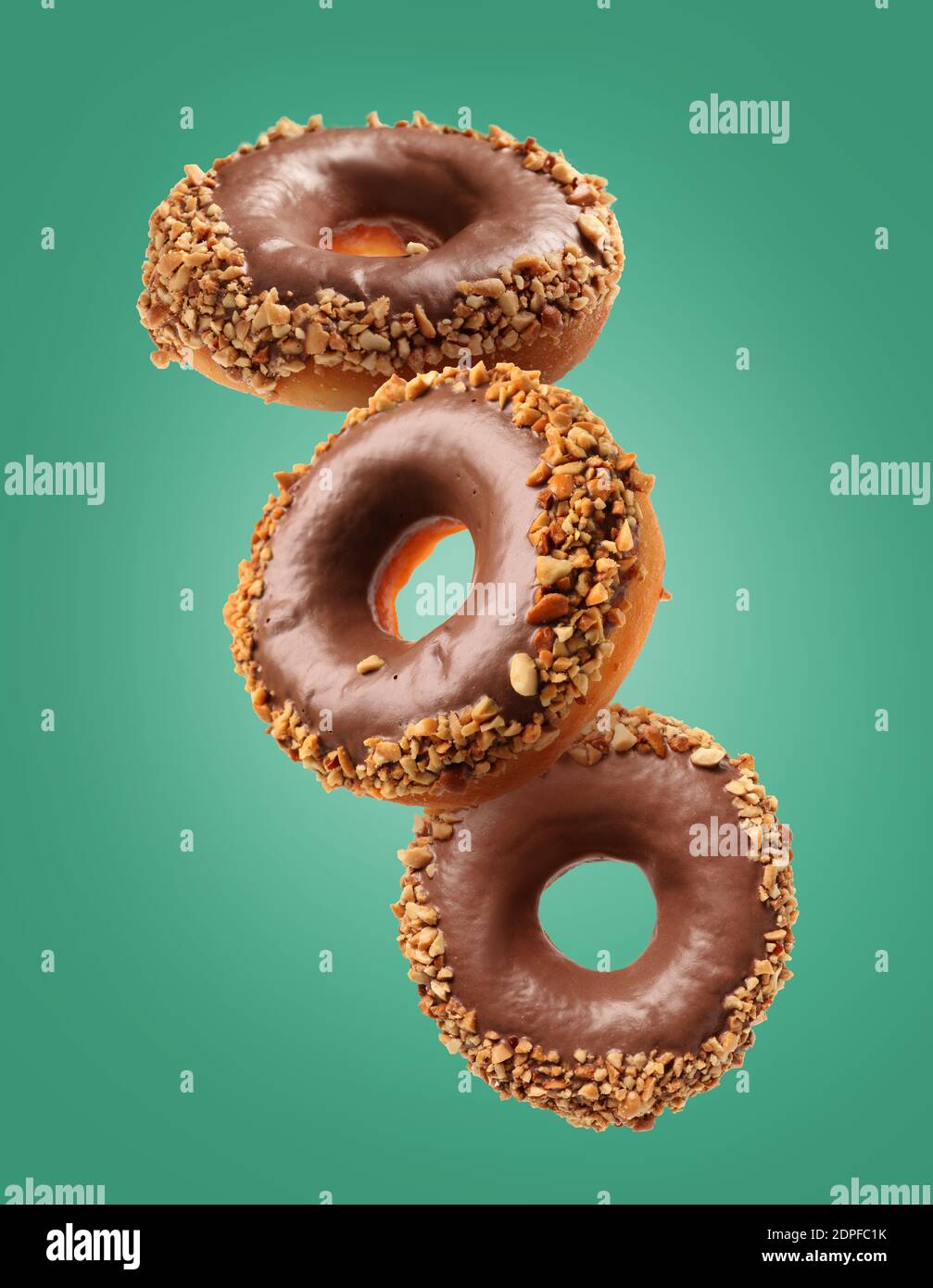 Sweet flying donuts on color background Stock Photo
