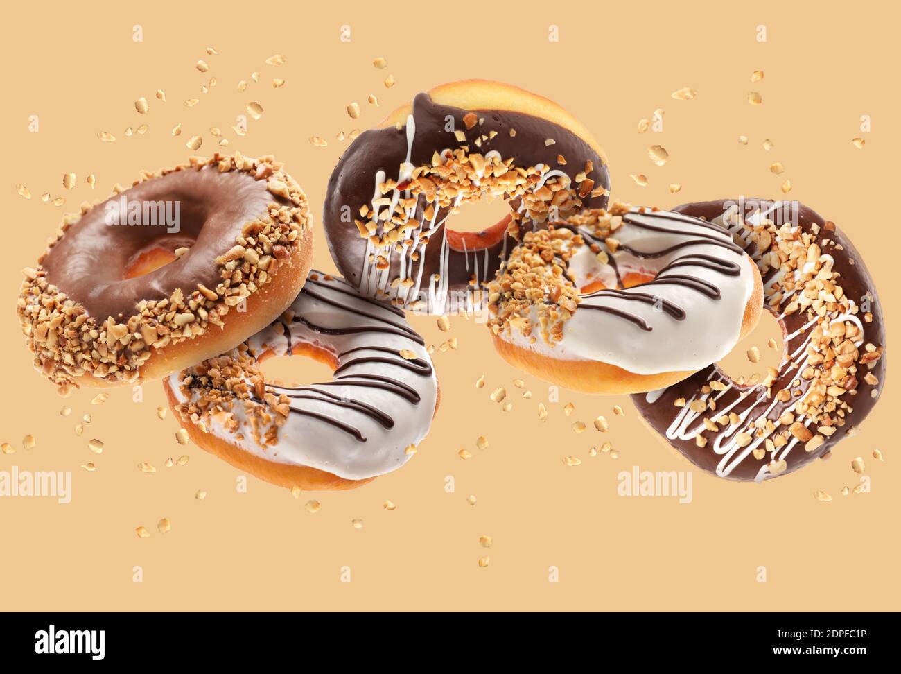 Sweet flying donuts on color background Stock Photo