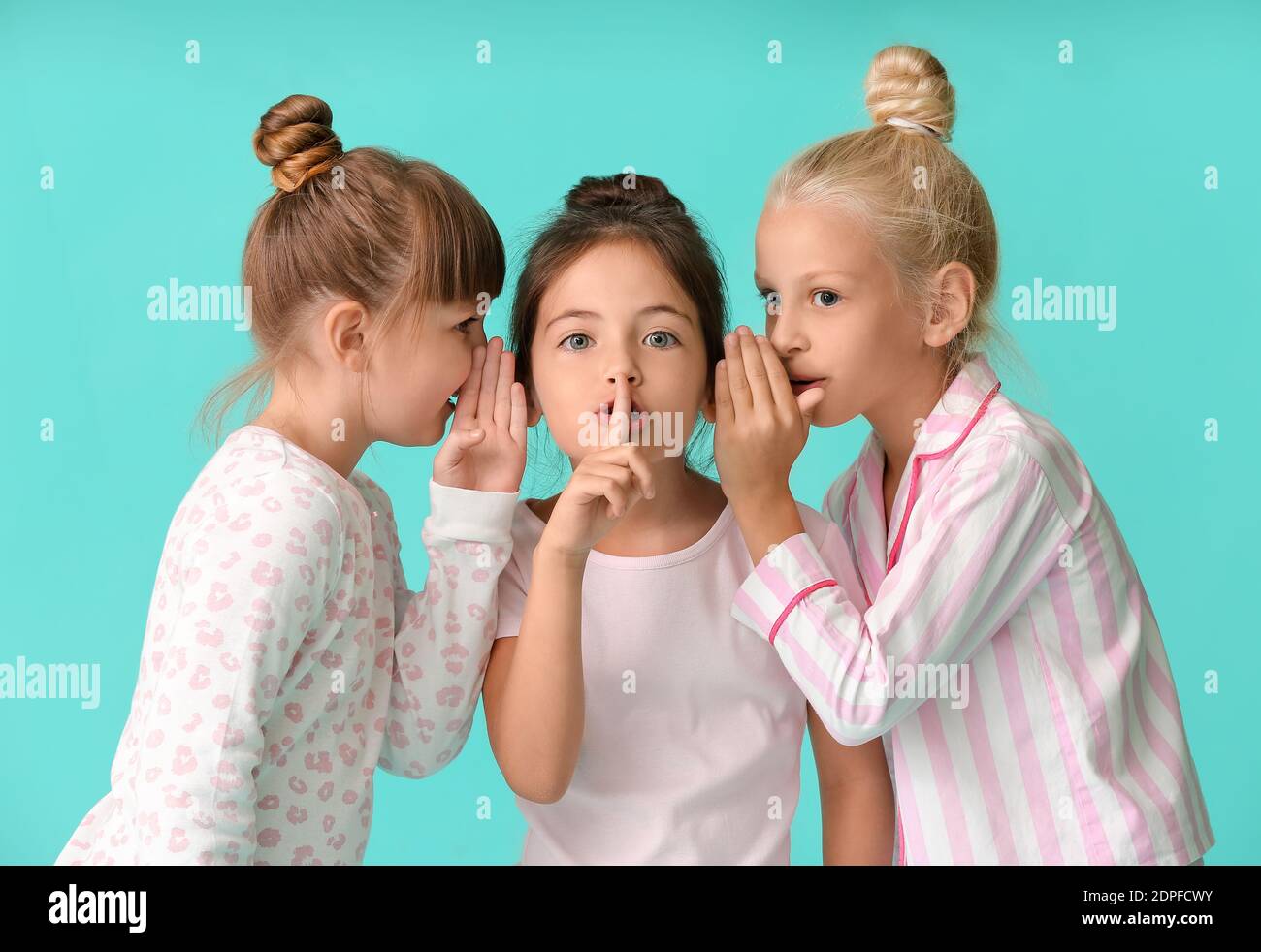Cute little girls in pajamas on color background Stock Photo - Alamy