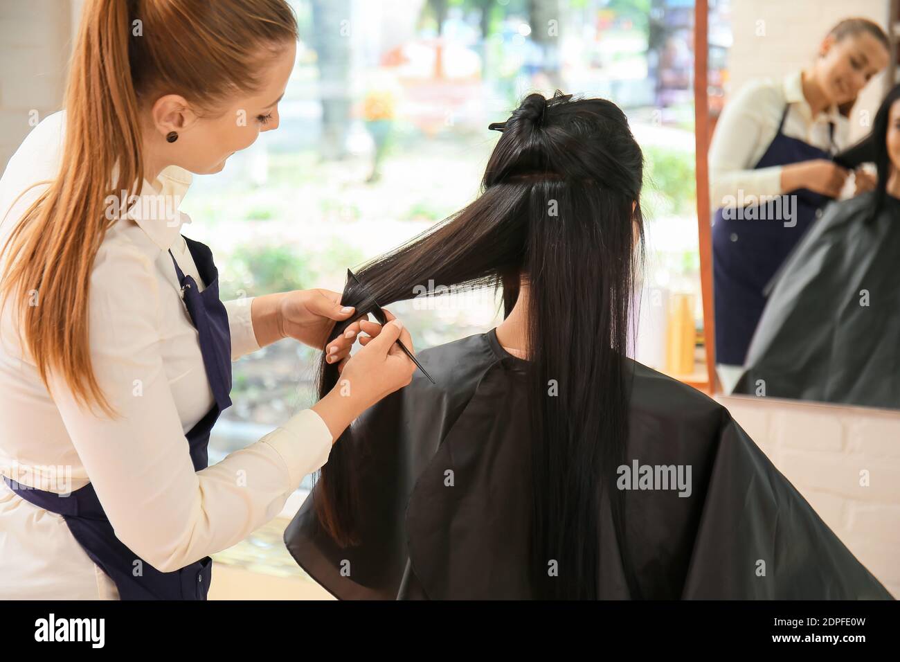 Female hairdresser working with client in salon Stock Photo - Alamy