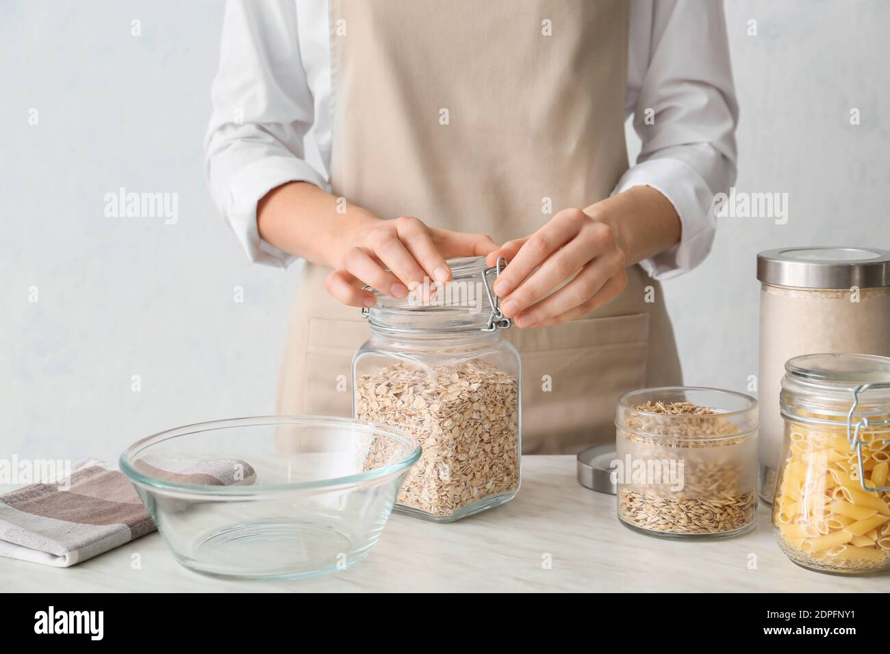 Woman cooking oat flakes in kitchen Stock Photo Alamy