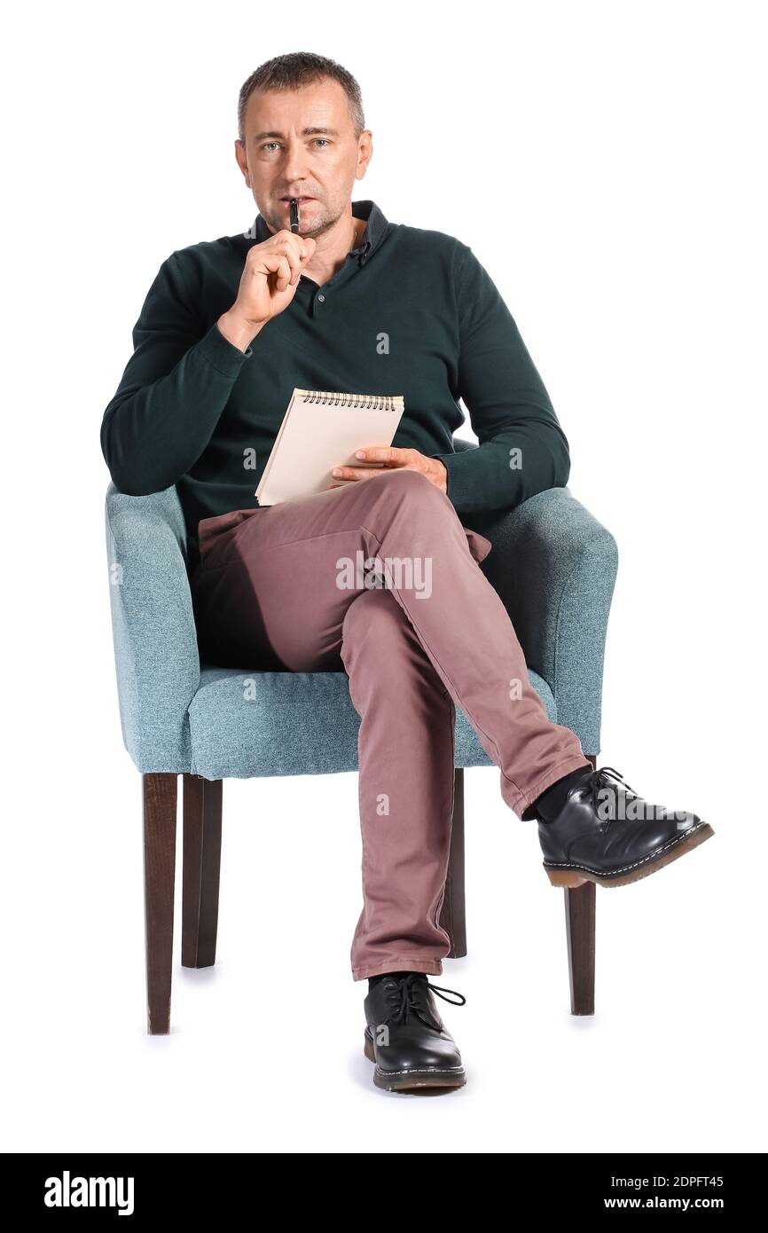 Male psychologist sitting in armchair against white background Stock