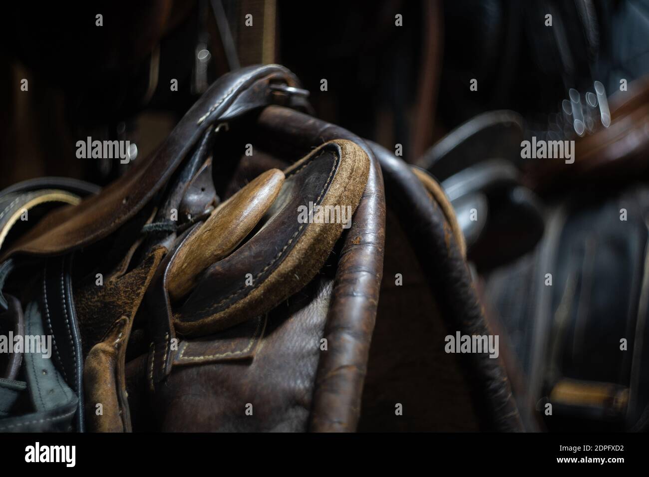 horse leather saddle hanging on a wooden wall Stock Photo Alamy