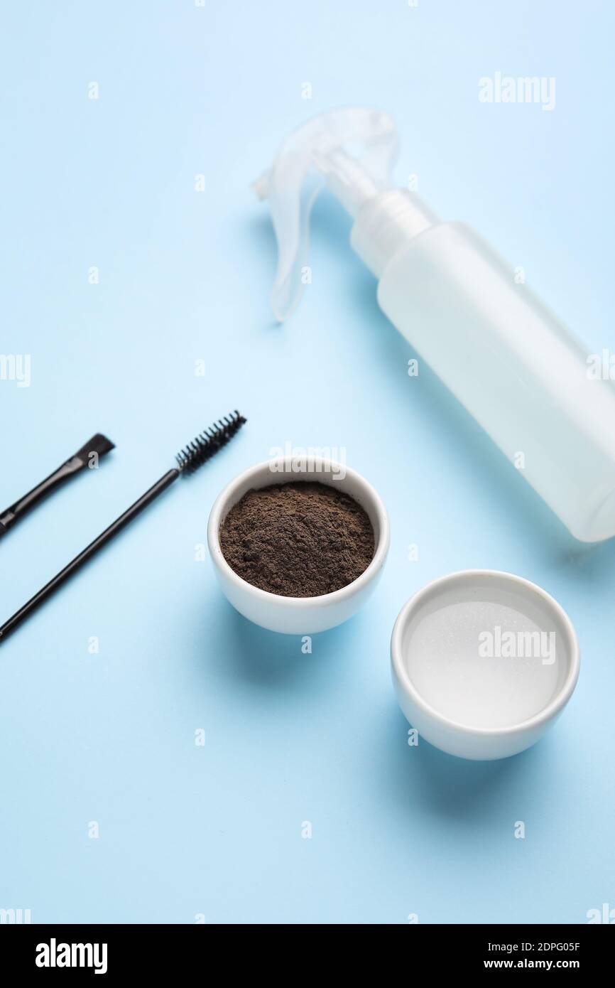Composition with henna for eyebrows correction on color background Stock Photo