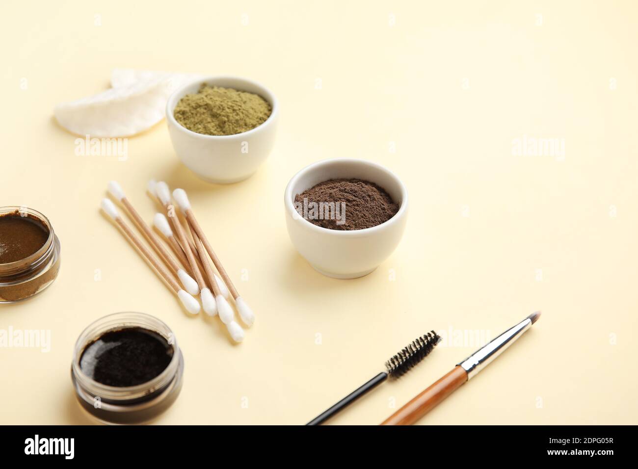Composition with henna for eyebrows correction on color background Stock Photo