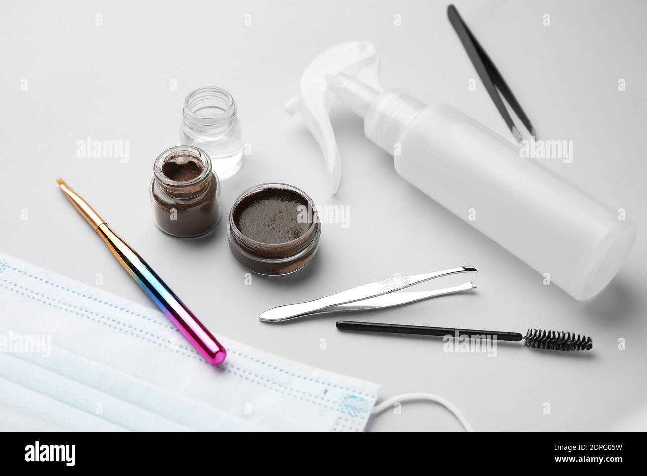Composition with henna for eyebrows correction on light background Stock Photo