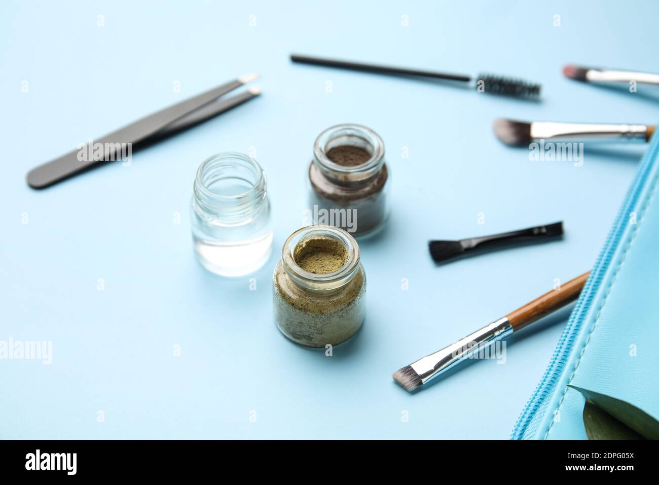 Composition with henna for eyebrows correction on color background Stock Photo