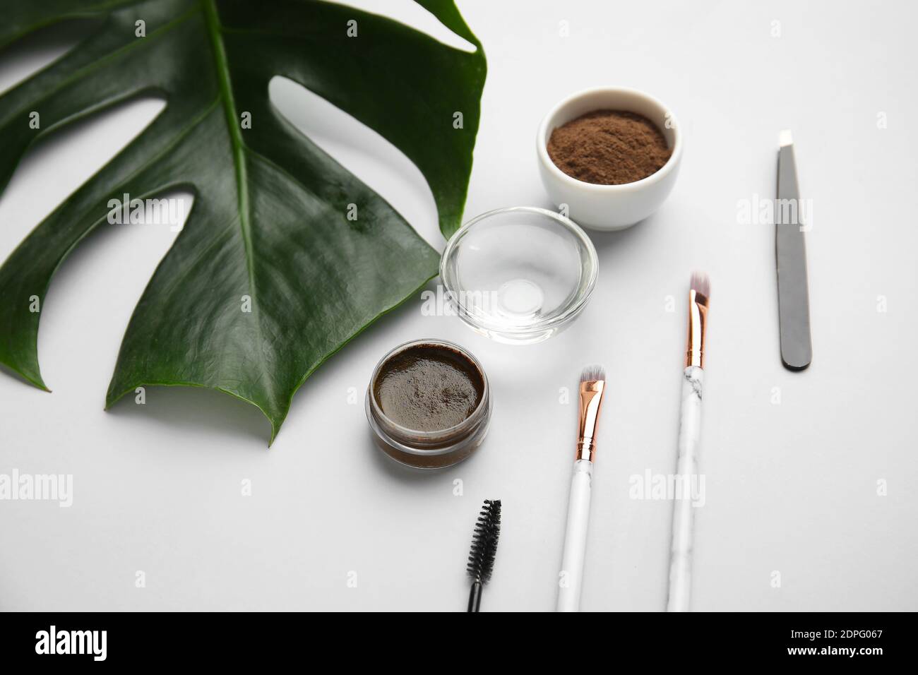 Composition with henna for eyebrows correction on light background Stock Photo