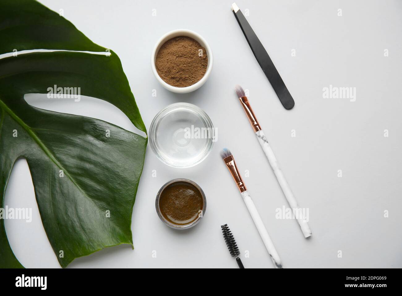 Composition with henna for eyebrows correction on light background Stock Photo