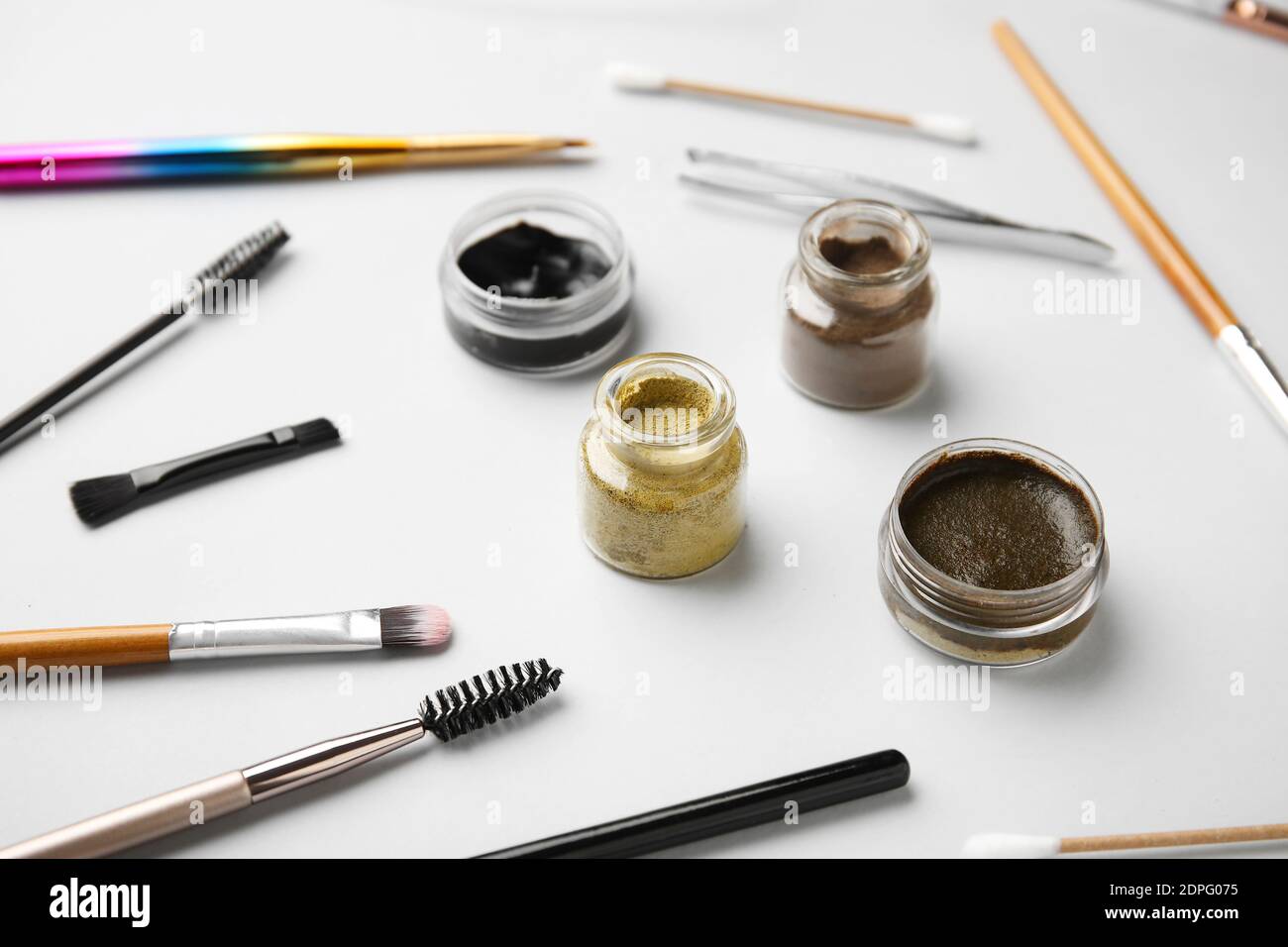 Composition with henna for eyebrows correction on light background Stock Photo