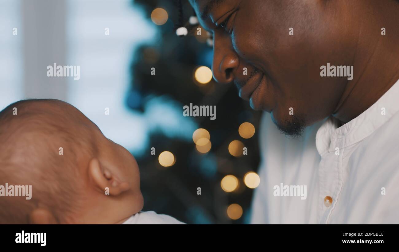 Beautiful multiracial family. Young black father holding his mulatto baby. Close up. High quality photo Stock Photo