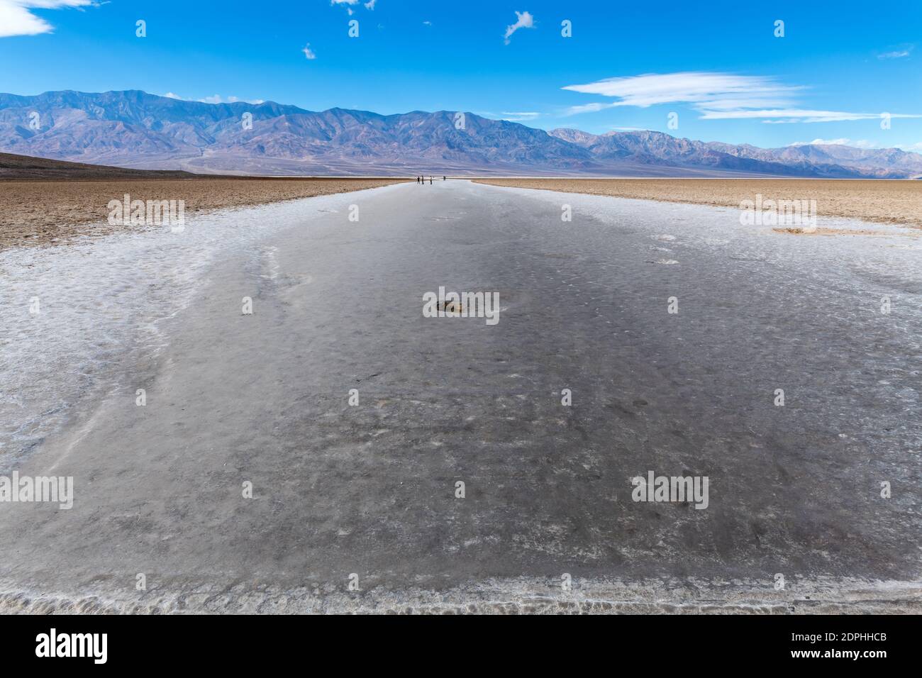 Hikers along the trail leading into Badwater Basin in Death Valley ...