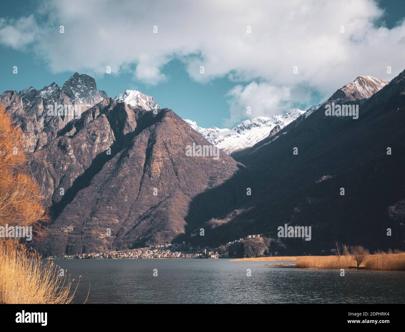 Scenic View Of Snowcapped Mountains By Lake Against Sky Stock Photo