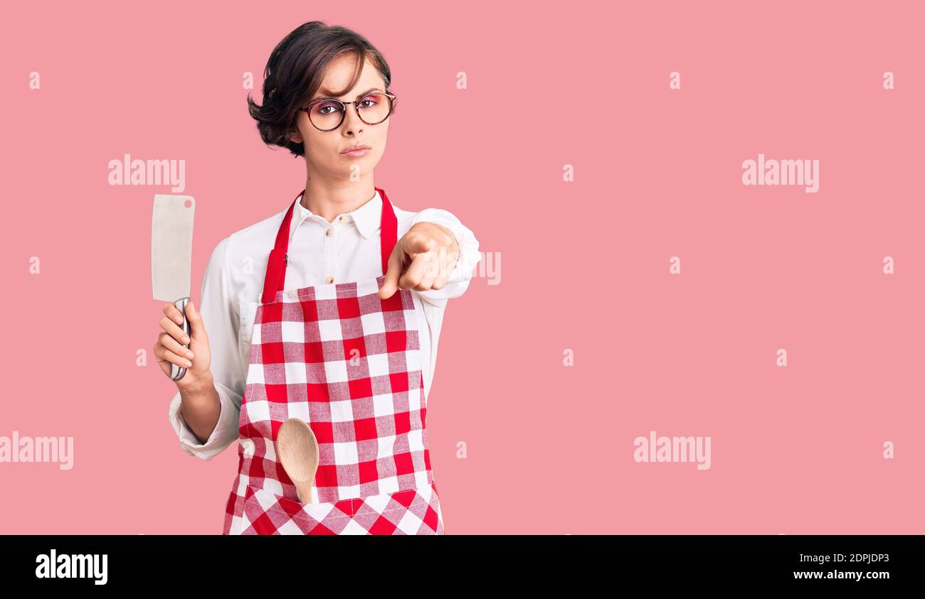 Beautiful Young Woman With Short Hair Wearing Professional Baker Apron Holding Knife Pointing With Finger To The Camera And To You Confident Gesture Stock Photo Alamy