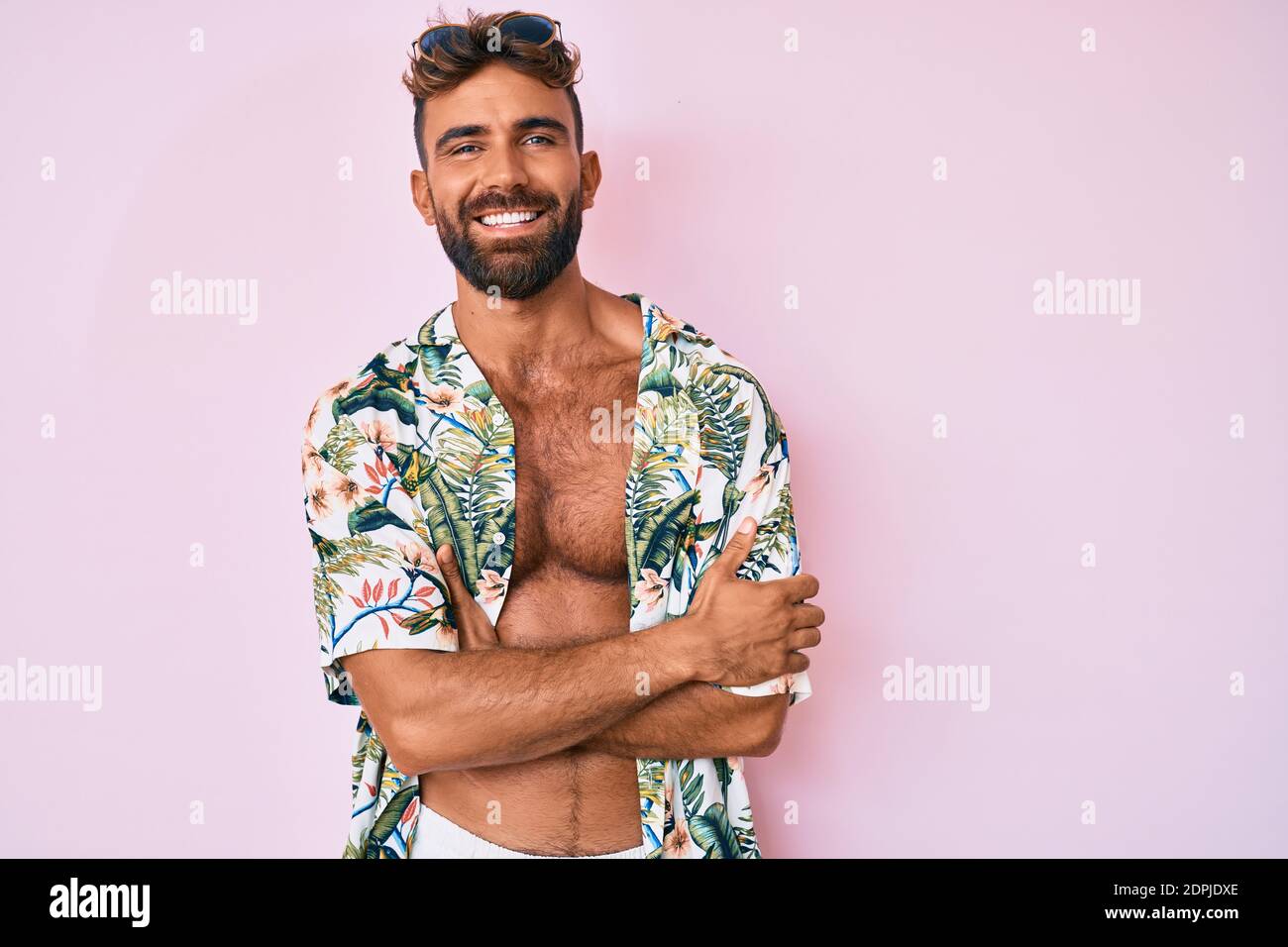 Young hispanic man wearing casual summer clothes thinking attitude and sober expression looking self confident Stock Photo