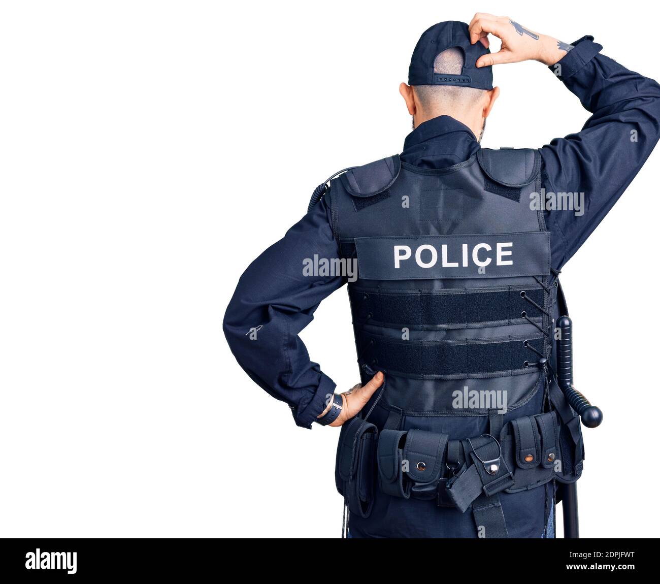 Young handsome man wearing police uniform backwards thinking about doubt with hand on head Stock Photo