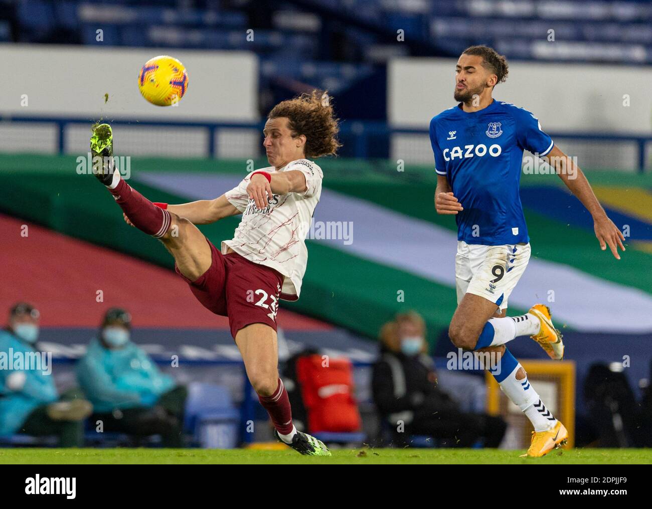 Liverpool. 20th Dec, 2020. Arsenal's David Luiz (L) clears the ball under pressure from Everton's Dominic Calvert-Lewin during the Premier League match between Everton FC and Arsenal FC in Liverpool, Britain, on Dec. 19, 2020. Credit: Xinhua/Alamy Live News Stock Photo