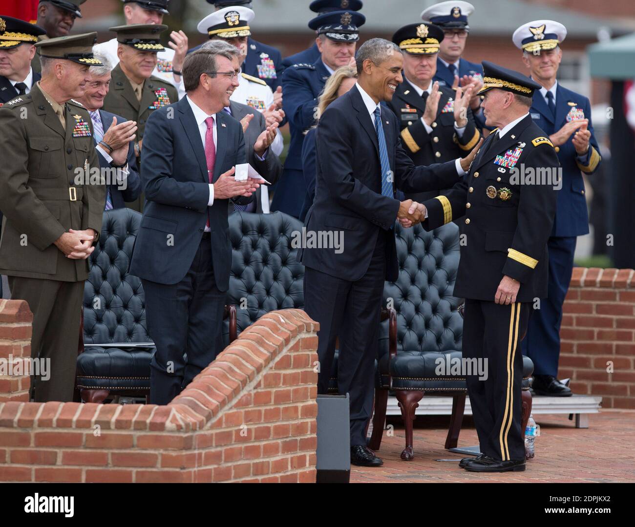 General Joseph Dunford, Defense Secretary Ashton Carter, and US President Barack Obama applaud General Martin Dempsey(right) at his retirement party at Fort Myer, Virginia, September 25, 2015. Photo by Chris Kleponis /Pool/ABACAPRESS.COM Stock Photo