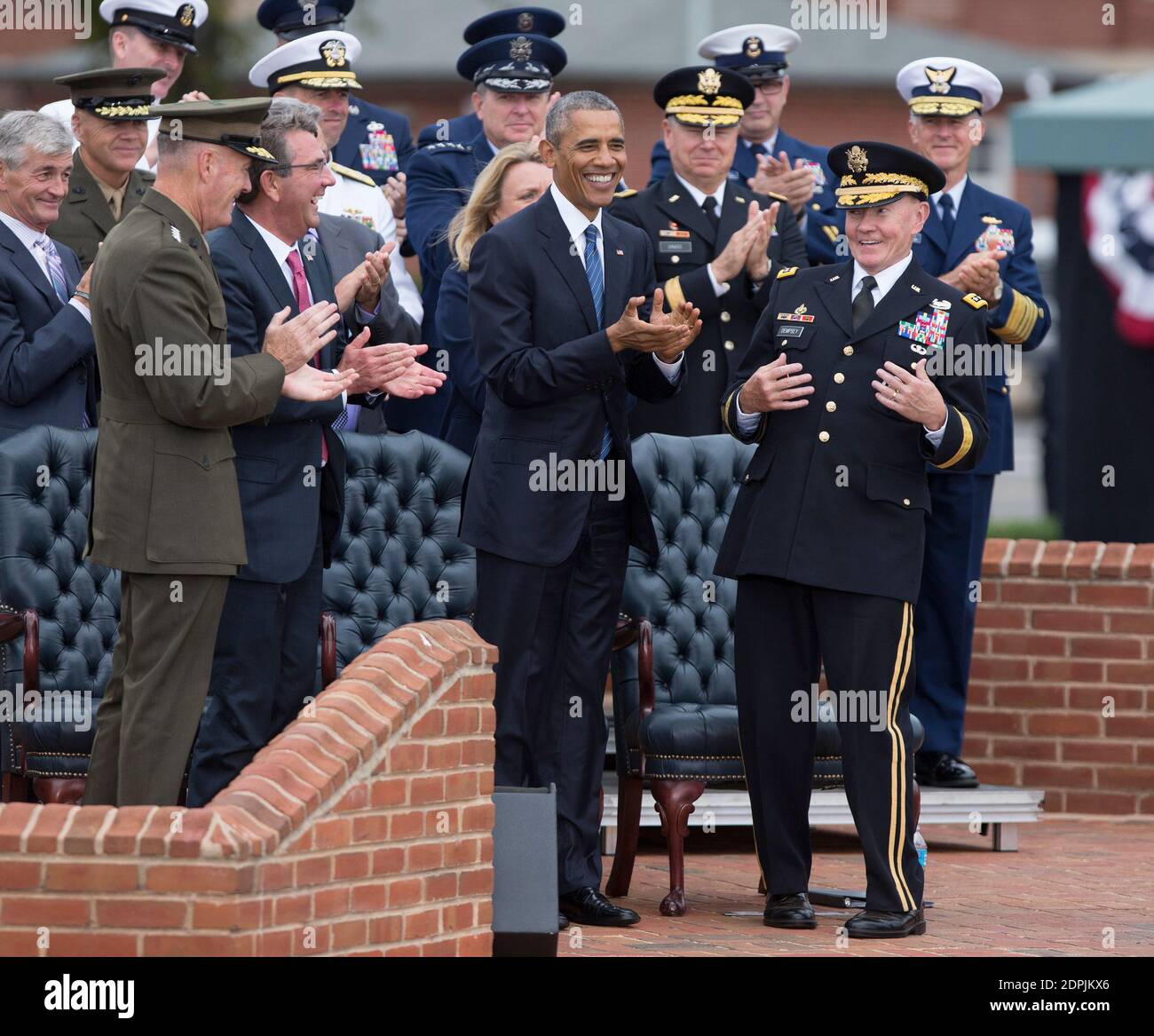 General Joseph Dunford, Defense Secretary Ashton Carter, and US President Barack Obama applaud General Martin Dempsey(right) at his retirement party at Fort Myer, Virginia, September 25, 2015. Photo by Chris Kleponis /Pool/ABACAPRESS.COM Stock Photo